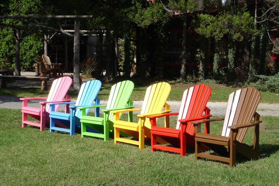 row of 6 different colored adirondack chairs