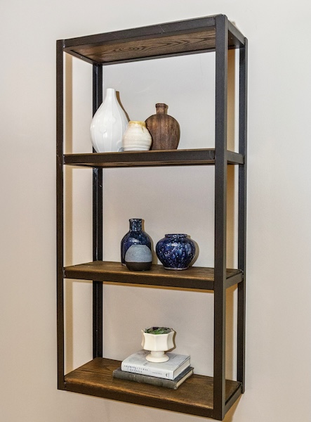 wall mounted shelving with books and vases