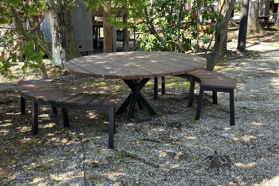 round outdoor table and arched benches